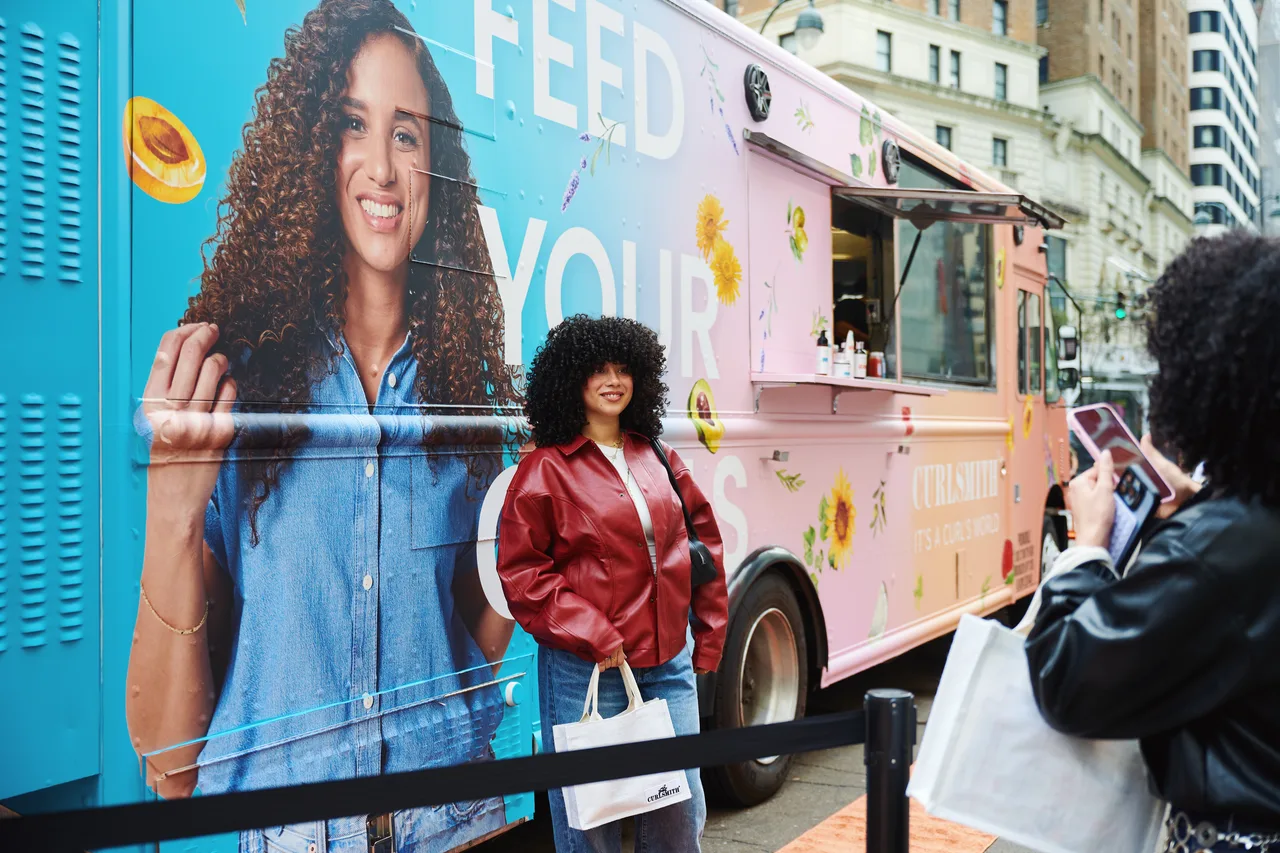 Curlsmith campaign on a branded sampling truck in New York, 2025