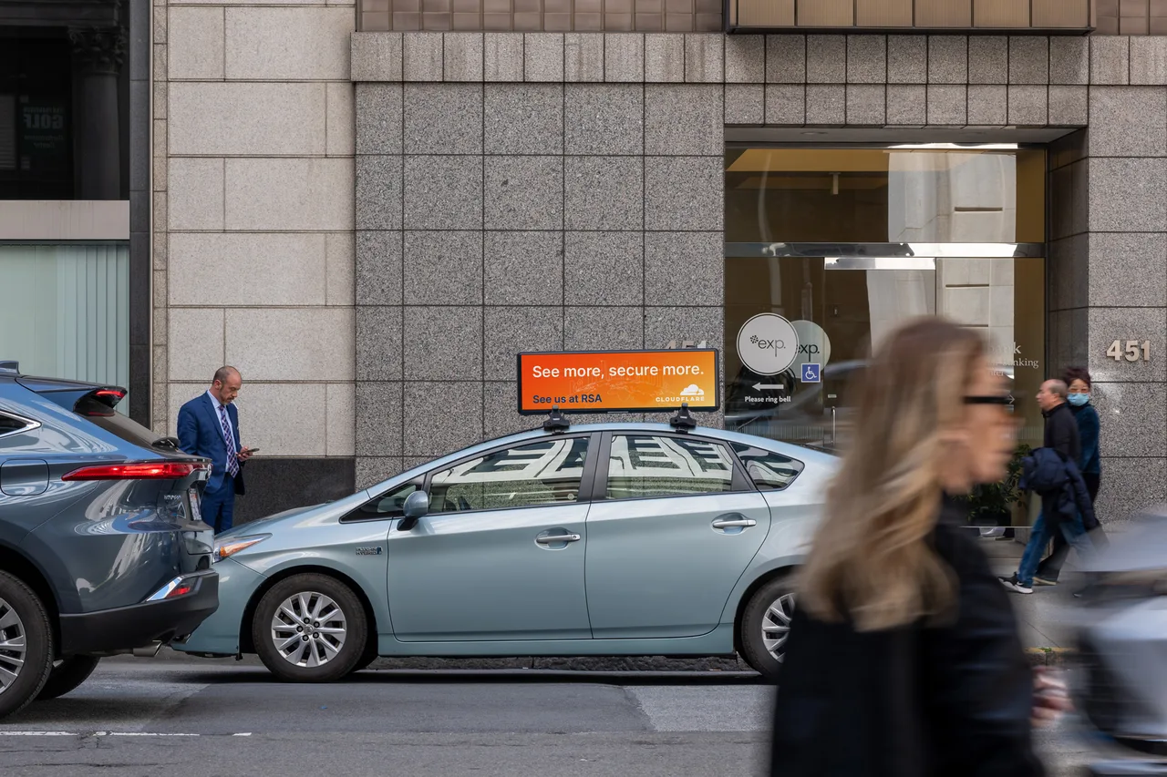 Cloudflare campaign on a digital car-top screen at downtown, RSA Conference week, San Francisco, 2023