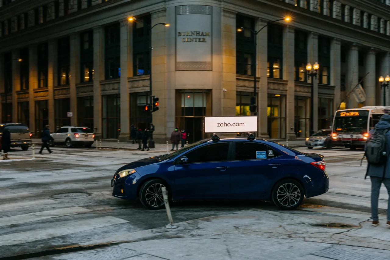 Zoho campaign on a digital car-top screen at Burnham Center, the Loop, Chicago, 2025