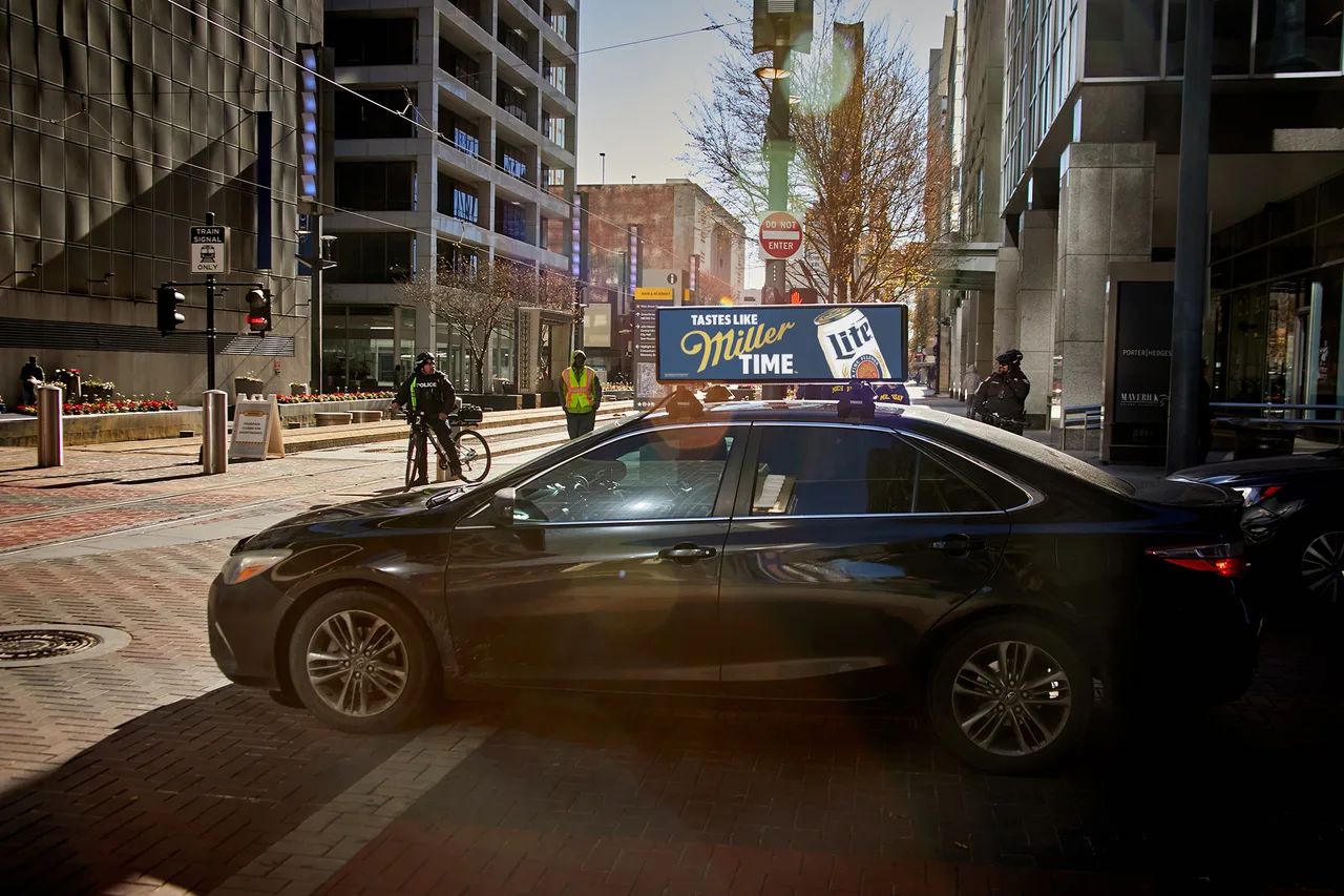 Miller Lite campaign on a digital car-top screen at Main Street light rail corridor, downtown, Houston