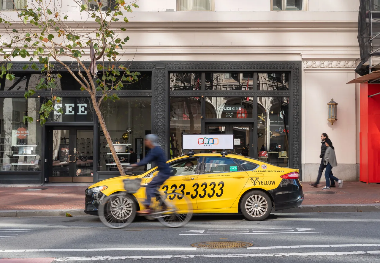 Zoho campaign on a digital taxi-top screen at Market Street, Yellow Cab, San Francisco, 2025