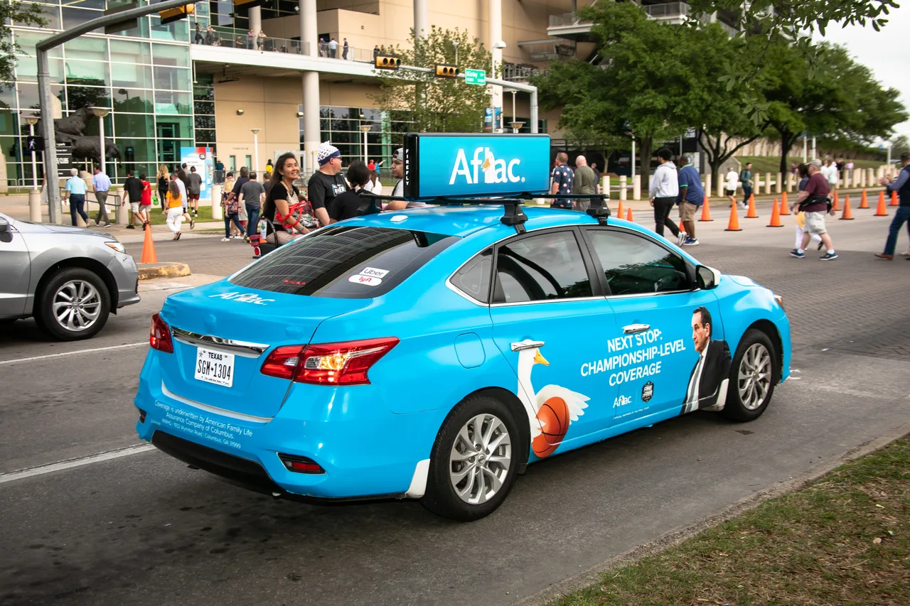 Aflac campaign on a wrapped car carrying a digital top at NRG Stadium, Houston