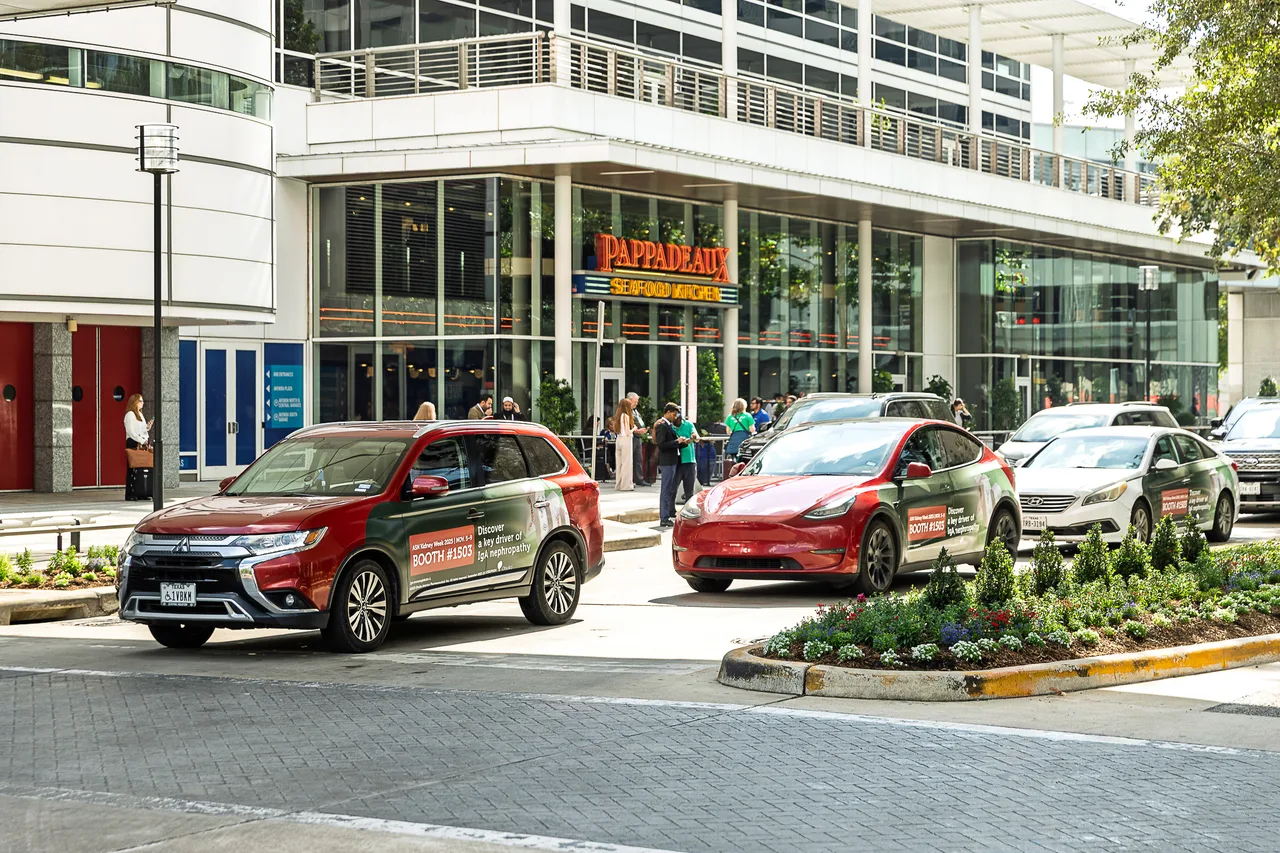 Otsuka campaign on a swarm of wrapped cars at convention district, three-car swarm, Houston, 2025