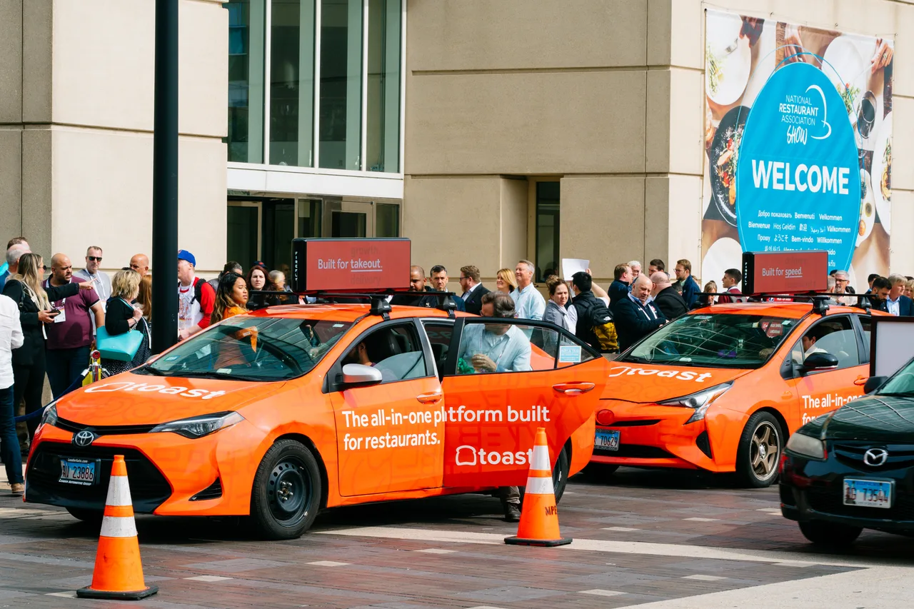 Vehicle wrap carrying a Toast campaign in Chicago