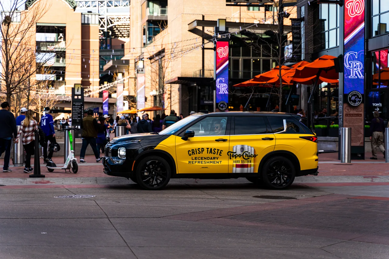 Vehicle wrap carrying a TopoChico campaign in Denver