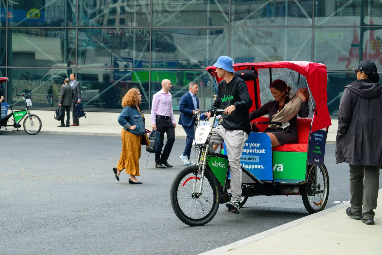 Workiva campaign on a wrapped pedicab in New York, 2024